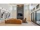 This living room features high ceilings, modern lighting, a cozy fireplace and comfortable seating arrangement at 14545 Lipan St, Westminster, CO 80023