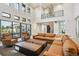 Open-concept living area with high ceilings, fireplace, balcony, and expansive sliding doors that lead to the outdoor space at 14545 Lipan St, Westminster, CO 80023
