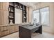 A well-appointed home office with built-in storage, sleek lighting, and a modern desk creates an ideal work environment at 14545 Lipan St, Westminster, CO 80023