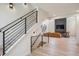 An open staircase leads to the living room with a modern fireplace and comfortable seating area at 14545 Lipan St, Westminster, CO 80023