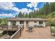 Expansive back deck with outdoor seating, ideal for enjoying scenic views and entertaining guests at 1774 Upper Bear Creek Rd, Evergreen, CO 80439