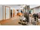 Spacious basement area with exercise equipment and wine storage, perfect for recreation and relaxation at 1774 Upper Bear Creek Rd, Evergreen, CO 80439