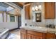Stylish bathroom with wood cabinets, unique fixtures, and a skylight for natural light at 1774 Upper Bear Creek Rd, Evergreen, CO 80439