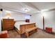 Basement bedroom with neutral tones, wooden bed frame, and ample lighting at 1774 Upper Bear Creek Rd, Evergreen, CO 80439