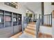 Open entryway with hardwood floors, a bookcase and stairs leading to upper level at 1774 Upper Bear Creek Rd, Evergreen, CO 80439