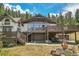 Unique home exterior featuring a two-story deck and stone detailing, blending charm and modern design at 1774 Upper Bear Creek Rd, Evergreen, CO 80439