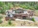 Charming home with large windows, spacious deck, and outdoor seating area, perfect for entertaining at 1774 Upper Bear Creek Rd, Evergreen, CO 80439