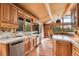 Open kitchen features a spacious counter, stainless steel appliances and wood cabinetry at 1774 Upper Bear Creek Rd, Evergreen, CO 80439