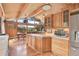 Bright kitchen with beautiful wood cabinetry, stainless steel appliances, and scenic views at 1774 Upper Bear Creek Rd, Evergreen, CO 80439