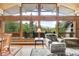 Bright living room with large windows offering beautiful views of the surrounding nature at 1774 Upper Bear Creek Rd, Evergreen, CO 80439