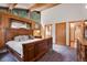 Elegant main bedroom with wood paneling and a large window offering scenic views at 1774 Upper Bear Creek Rd, Evergreen, CO 80439