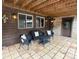 Charming outdoor patio with stone flooring, a wicker furniture set and wood ceiling at 1774 Upper Bear Creek Rd, Evergreen, CO 80439
