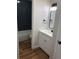 Modern bathroom boasts a white vanity, black hardware, and subway tiled shower and tub at 5875 E Iliff Ave # 203, Denver, CO 80222