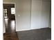 Bedroom with carpeted floor, closet and a view of the living room at 5875 E Iliff Ave # 203, Denver, CO 80222