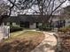 A walkable, landscaped path leads to multi-Gathering building with lush trees, bushes, and green space at 5875 E Iliff Ave # 203, Denver, CO 80222