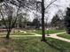 Scenic green space with well-maintained lawns, pathways, landscaping, and mature trees for relaxed outdoor living at 5875 E Iliff Ave # 203, Denver, CO 80222