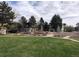 Lush green lawn and garden plots surrounded by trees enhance the community and provide an inviting, park-like setting at 5875 E Iliff Ave # 203, Denver, CO 80222