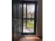 This door opens to an exterior view of a green space in the community at 5875 E Iliff Ave # 203, Denver, CO 80222