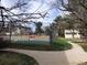 Outdoor tennis court and manicured walkways create recreational and social opportunities for residents at 5875 E Iliff Ave # 203, Denver, CO 80222