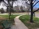 Scenic walking path and neighborhood park-like setting with benches, grass, and mature trees at 5875 E Iliff Ave # 203, Denver, CO 80222
