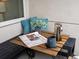 Cozy balcony with a small table, newspaper, coffee, and charming decor for relaxing outdoors at 1898 S Bannock St # 209, Denver, CO 80223