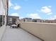 Large balcony with lounge seating, offering a private outdoor space with neighborhood views at 1898 S Bannock St # 209, Denver, CO 80223