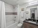 Bathroom with tiled shower and vanity at 1898 S Bannock St # 209, Denver, CO 80223