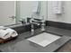 Bathroom vanity features a modern faucet, and a sleek gray countertop with fresh towels on a wooden tray at 1898 S Bannock St # 209, Denver, CO 80223