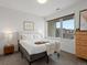 Bright bedroom features a large window, comfortable bed, and contemporary decor at 1898 S Bannock St # 209, Denver, CO 80223