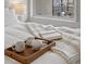 Cozy bedroom features a bed with natural light, a book, and a decorative blanket at 1898 S Bannock St # 209, Denver, CO 80223
