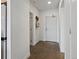 Bright hallway with hardwood floors and white walls leading to various rooms at 1898 S Bannock St # 209, Denver, CO 80223