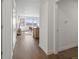 Hallway view showing hardwood floors and access to the living area and bedrooms at 1898 S Bannock St # 209, Denver, CO 80223