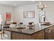 Close-up of a kitchen island featuring seating and views of the living area at 1898 S Bannock St # 209, Denver, CO 80223