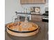 Modern kitchen island features wood tray with glasses and liquor decanter at 1898 S Bannock St # 209, Denver, CO 80223
