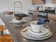 Close-up of kitchen island with sleek countertop featuring bar seating and decorative tableware at 1898 S Bannock St # 209, Denver, CO 80223