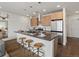 Modern kitchen island with seating, stainless steel appliances, and stylish pendant lighting at 1898 S Bannock St # 209, Denver, CO 80223