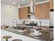 Modern kitchen boasts wood cabinetry, stainless steel appliances, and center island with bar stool seating at 1898 S Bannock St # 209, Denver, CO 80223