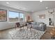 Spacious living room featuring a large window, comfortable seating, and stylish decor at 1898 S Bannock St # 209, Denver, CO 80223