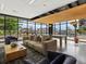 Bright living room features large windows, modern furniture, and a ping pong table for recreation at 1898 S Bannock St # 209, Denver, CO 80223
