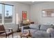Living area showcases a workspace, comfortable seating, and decor with natural lighting at 1898 S Bannock St # 209, Denver, CO 80223