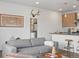 Cozy living area adjacent to kitchen with seating and decor creating a welcoming atmosphere at 1898 S Bannock St # 209, Denver, CO 80223