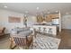 Open-concept living room and kitchen with modern finishes and hardwood flooring at 1898 S Bannock St # 209, Denver, CO 80223