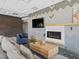 Modern lounge features a cozy fireplace, sleek TV, and comfortable seating, enhancing the apartment's appeal at 1898 S Bannock St # 209, Denver, CO 80223