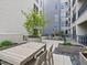 Inviting condo patio with a dining table, chairs, and lush landscaping, creating a perfect outdoor retreat at 1898 S Bannock St # 209, Denver, CO 80223