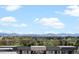 Breathtaking view of lush golf course, verdant trees, and majestic mountains from the home at 1898 S Bannock St # 209, Denver, CO 80223
