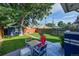 Inviting backyard with a patio featuring outdoor seating, lush grass, and a detached garage at 706 S Lincoln St, Denver, CO 80209