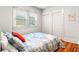 Cozy bedroom featuring hardwood floors, bright window, and a closet with sliding doors at 706 S Lincoln St, Denver, CO 80209