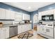 Functional kitchen with white cabinets, stainless steel appliances, and bright tile flooring at 706 S Lincoln St, Denver, CO 80209