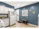 Cozy kitchen featuring white cabinets, tile flooring, and modern appliances, creating a functional space at 706 S Lincoln St, Denver, CO 80209
