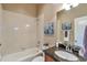 Clean bathroom featuring a bathtub, shower, vanity with granite countertop, and ample lighting at 8537 E 35Th Ave, Denver, CO 80238